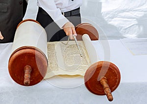 Hand of boy reading the Jewish Torah at Bar Mitzvah