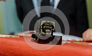 Hand of boy reading the Jewish Torah at Bar Mitzvah