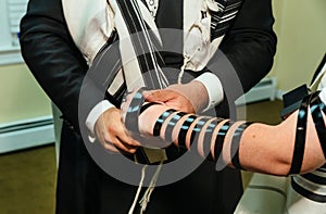 Hand of boy reading the Jewish Torah Bar Mitzvah