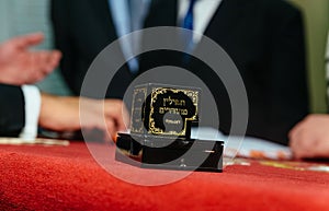 Hand of boy reading the Jewish Torah at Bar Mitzvah