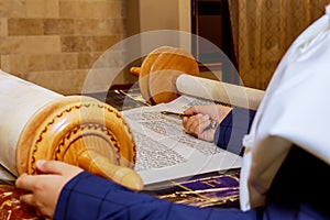 Hand of boy reading the Jewish Torah at Bar Mitzvah Bar Mitzvah Torah reading