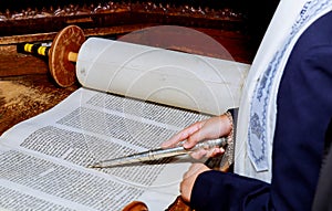 Hand of boy reading the Jewish Torah at Bar Mitzvah Bar Mitzvah Torah reading