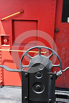 The hand brake wheel on old red caboose