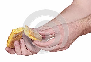 Hand breaking apart a bread