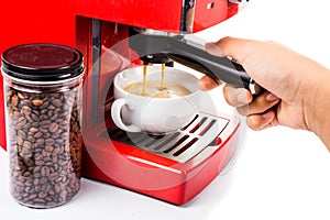 Hand brewing coffee with a bright red color espresso coffee machine photo