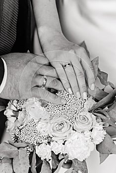 Hand of the bride with a ring holds a wedding bouquet. Wedding decorations. Close-up. The bride`s bouquet