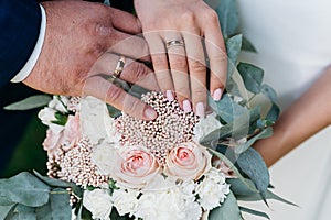 Hand of the bride with a ring holds a wedding bouquet Wedding decorations. Close-up. The bride`s bouquet