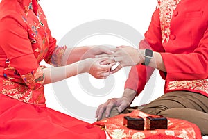 Hand of the bride wears wedding ring to his the groom. Love concepts