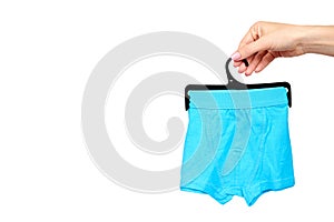 Hand with bright boxer underwear, cotton pants