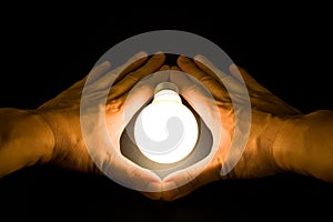 Hand and a Bright Light Bulb