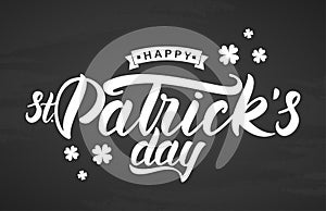 Hand brush lettering of Happy St. Patrick`s Day on chalkboard background. Typography design