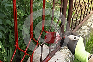 Hand with brush that painting metal railing construction