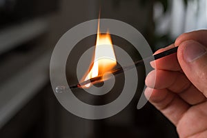 Hand with burning match. Power and energy.