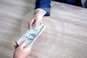 Hand of business giving or paying money