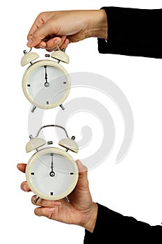 Hand of business hold alarm clock with showing 12 o`clock isolated on white - Time concept