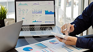 Hand of a business man using a calculator to check financial accounts, check expenditures and company