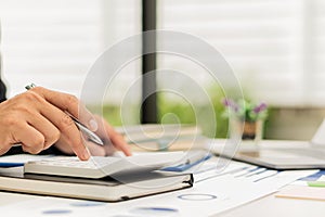 Hand of a business man using a calculator to check financial accounts, check expenditures and company