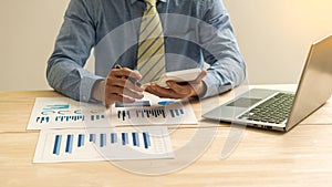 Hand of a business man using a calculator to check financial accounts, check expenditures and company