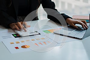 Hand of a business man using a calculator to check financial accounts, check expenditures and company