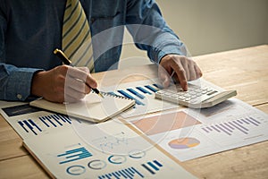 Hand of a business man using a calculator to check financial accounts, check expenditures and company