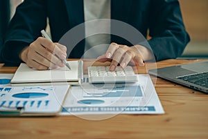 Hand of a business man using a calculator to check financial accounts, check expenditures and company