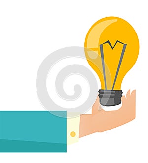 Hand of business person holding bright light bulb.