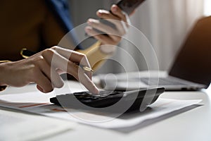 Hand business woman doing finances and calculate on desk about cost at office