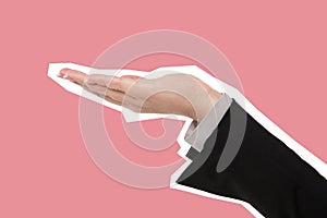 Hand of business woman holding copy space. Magazine style  on pink background