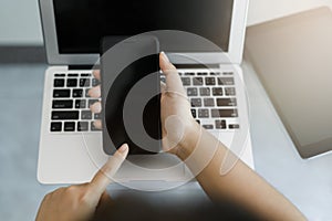 Hand of a business woman holding a phone