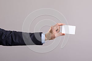 Hand of a businessman with a blank card