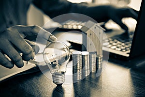 Hand businessman choose light bulb with coin stack in graph concept of creative financial planning idea and startup marketing