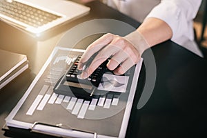 Hand businessman doing finances and calculate on desk.