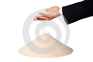 Hand of businessman with falling sand on pile