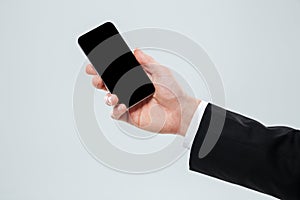 Hand of businessman holding blank screen mobile phone