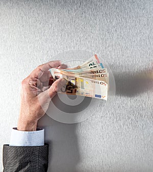 Hand of businessman holding euro bank notes for corporate money