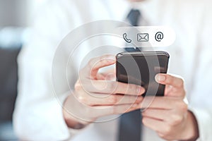 Hand of Businessman holding mobile smartphone with  mail,phone,email  icon.