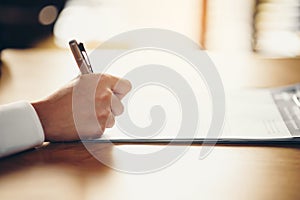 Hand of a businessman holding a pen is analyzing, business planner.For profit and stability of business sustainability