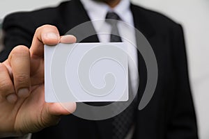 Hand of businessman holding the white card on white.