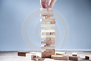 Hand of businessman holding wooden blcoks and wooden blcoks isolated on gray background. Strategy as business plan for team work