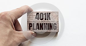 Hand of a businessman holding wooden blocks. Conceptual image. Text 401k planning concept business succeed