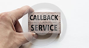 Hand of a businessman holding wooden blocks. Conceptual image. Text callback service concept business succeed