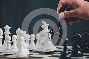 Hand of Businessman play with chess game. concept of business strategy and tactic.strategy, management or leadership concept