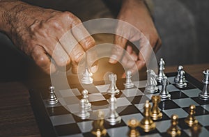 Hand of businessman playing chess .assume making strategy management busninessman plan