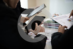 Hand of businessman pointing to Digital tablet, graphs, business