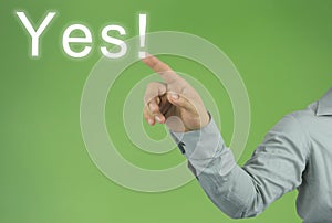 hand of the businessman pointing to the Yes! text on green background.