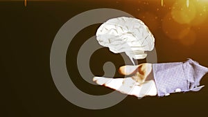 Hand of a businessman raises computer brain