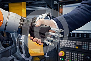 Hand of a businessman shaking hands with a Android robot