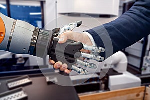 Hand of a businessman shaking hands with a Android robot