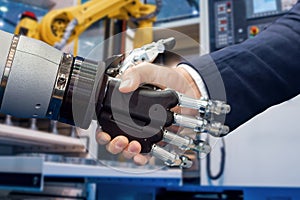 Hand of a businessman shaking hands with a Android robot