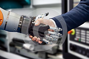 Hand of a businessman shaking hands with a Android robot